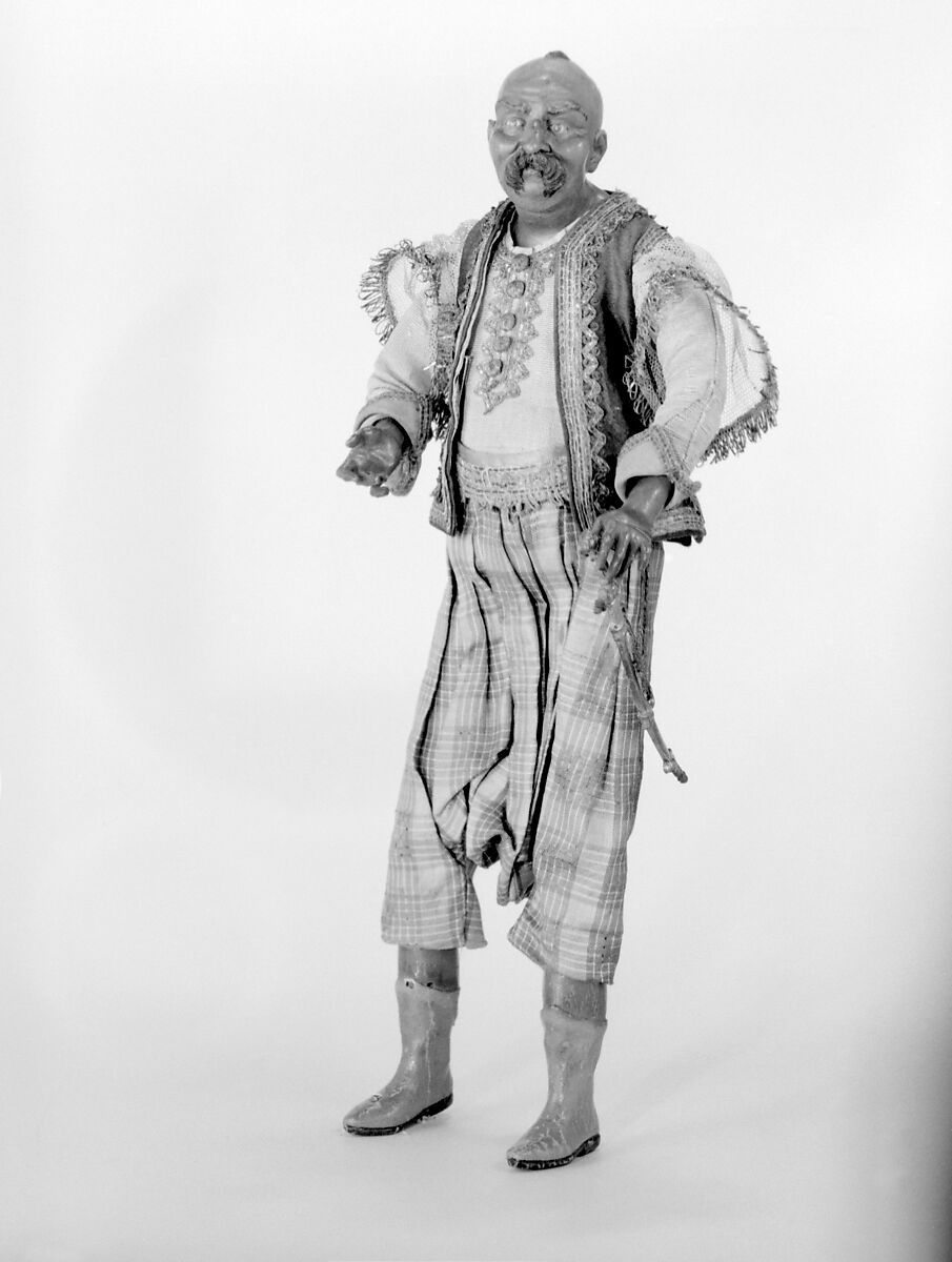 King's attendant, Polychromed terracotta head; wooden limbs; body of wire wrapped in tow; silk garments with silver and gold thread and buttons; gilt-metal sword, Italian, Naples