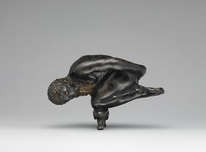 Oil lamp in the form of a bearded athlete balanced on his knees