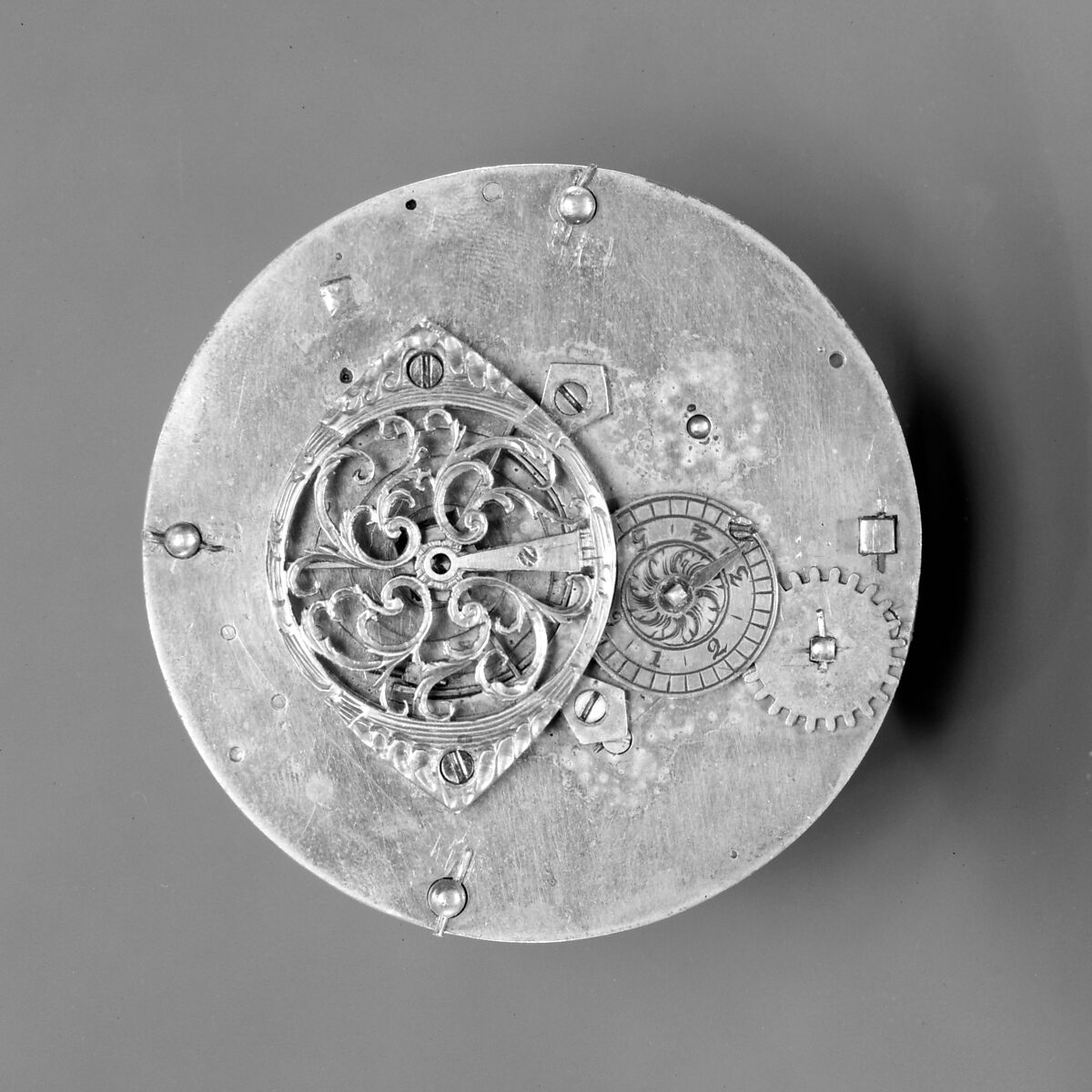 Mantel clock, Case: carved and gilded wood; Revolving rings for hours and minutes: gilded brass; Movement: brass and steel, probably Austrian