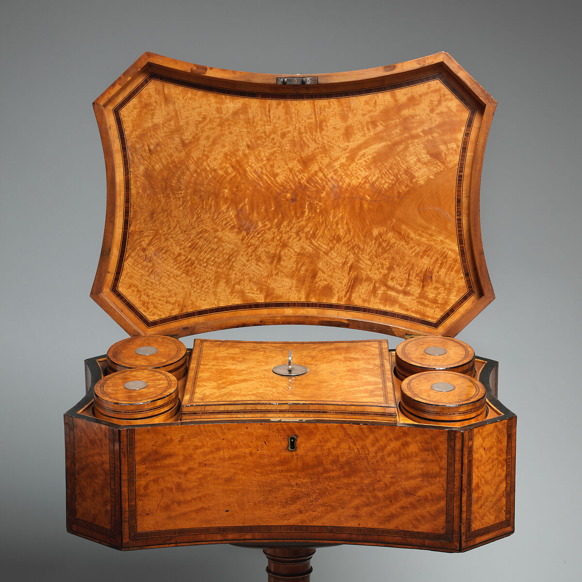 Teapoy with four oval tea caddies, Satinwood veneer, inlaid with rosewood, holly and ebony, British