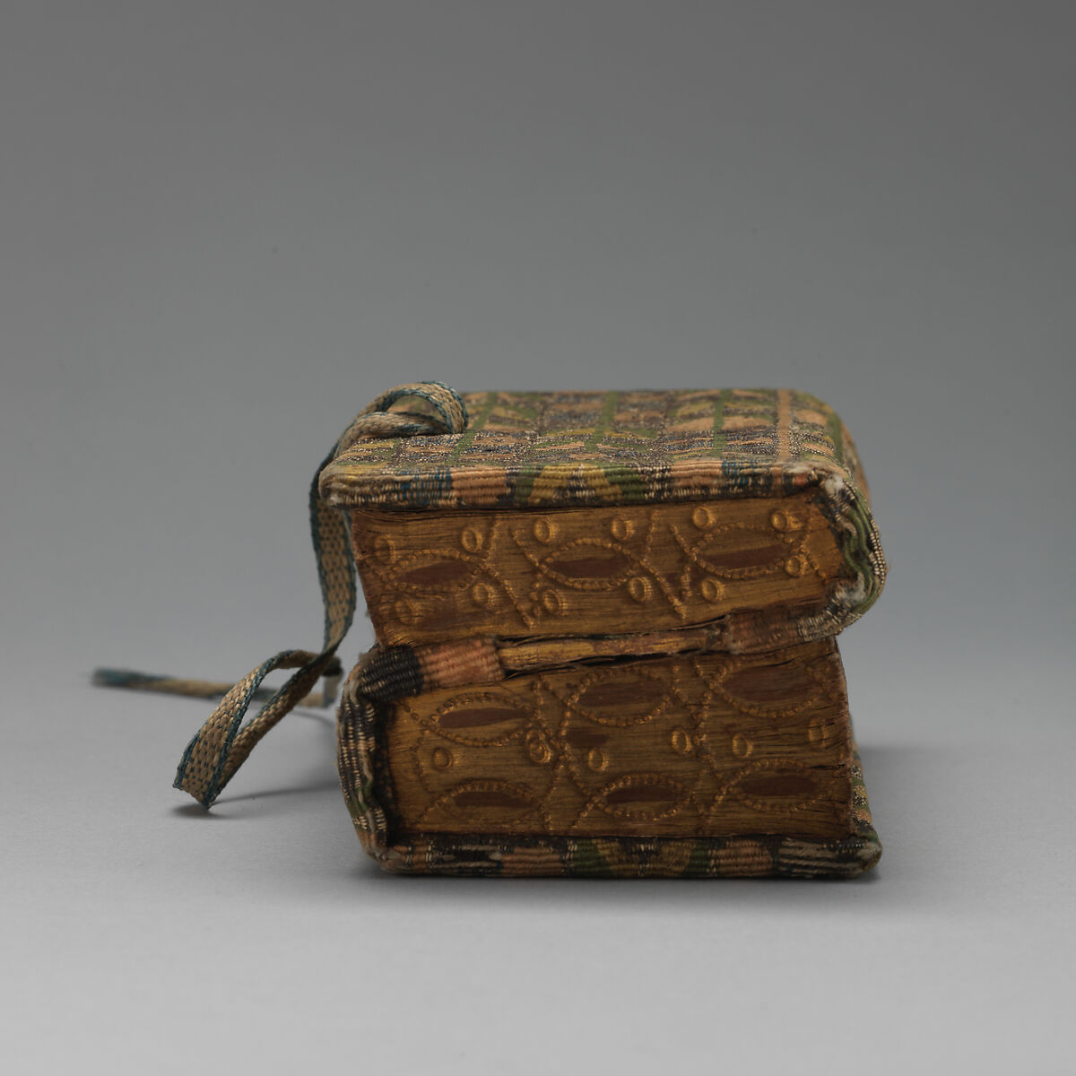 Bookbinding of repeat foliate pattern, Attributed to the weaving workshop funded by William Sheldon (Barcheston, Warwickshire and Bordesley, Worcestershire), Wool, silk, silver-metal-wrapped thread, containing a seventeenth-century printed book, British, possibly Barcheston or Bordesley