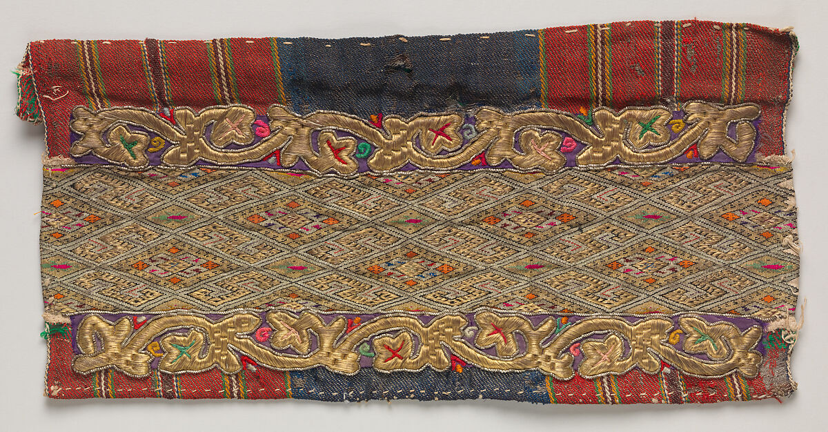 Fragment from an apron (opreg cu ciucuri), Background: twill weave (warp: Turcana wool, Z spun, 24 per cm; weft: metal-wrapped thread; wool, Z spun, 14 per cm; cotton, 2Z spun, S plied); decorative panel: tapestry weave (warp: cotton, 2Z spun, S pliz, 16 per cm; weft: linen, Z spun, 38 per cm; silk, 2Z spun, S plied; metal-wrapped thread, 64 per cm); embroidery: metal-wrapped thread, metal coil, Romanian, Banat area 