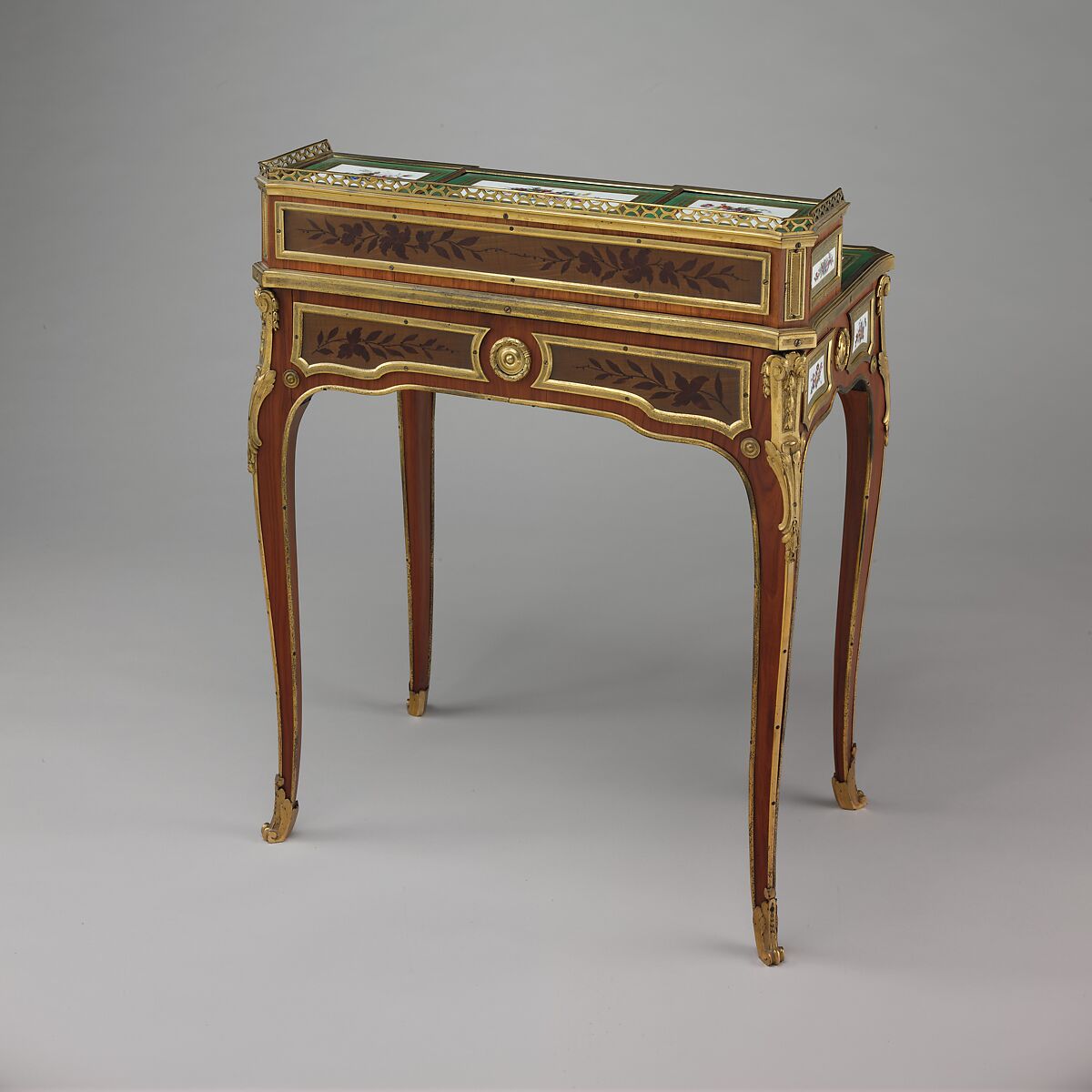 Small writing desk (bonheur-du-jour), Martin Carlin (French, near Freiburg im Breisgau ca. 1730–1785 Paris), Oak veneered with tulipwood, amaranth, and stained sycamore; mahogany; seventeen soft-paste porcelain plaques; gilt-bronze mounts; velvet (not original), French, Paris and Sèvres