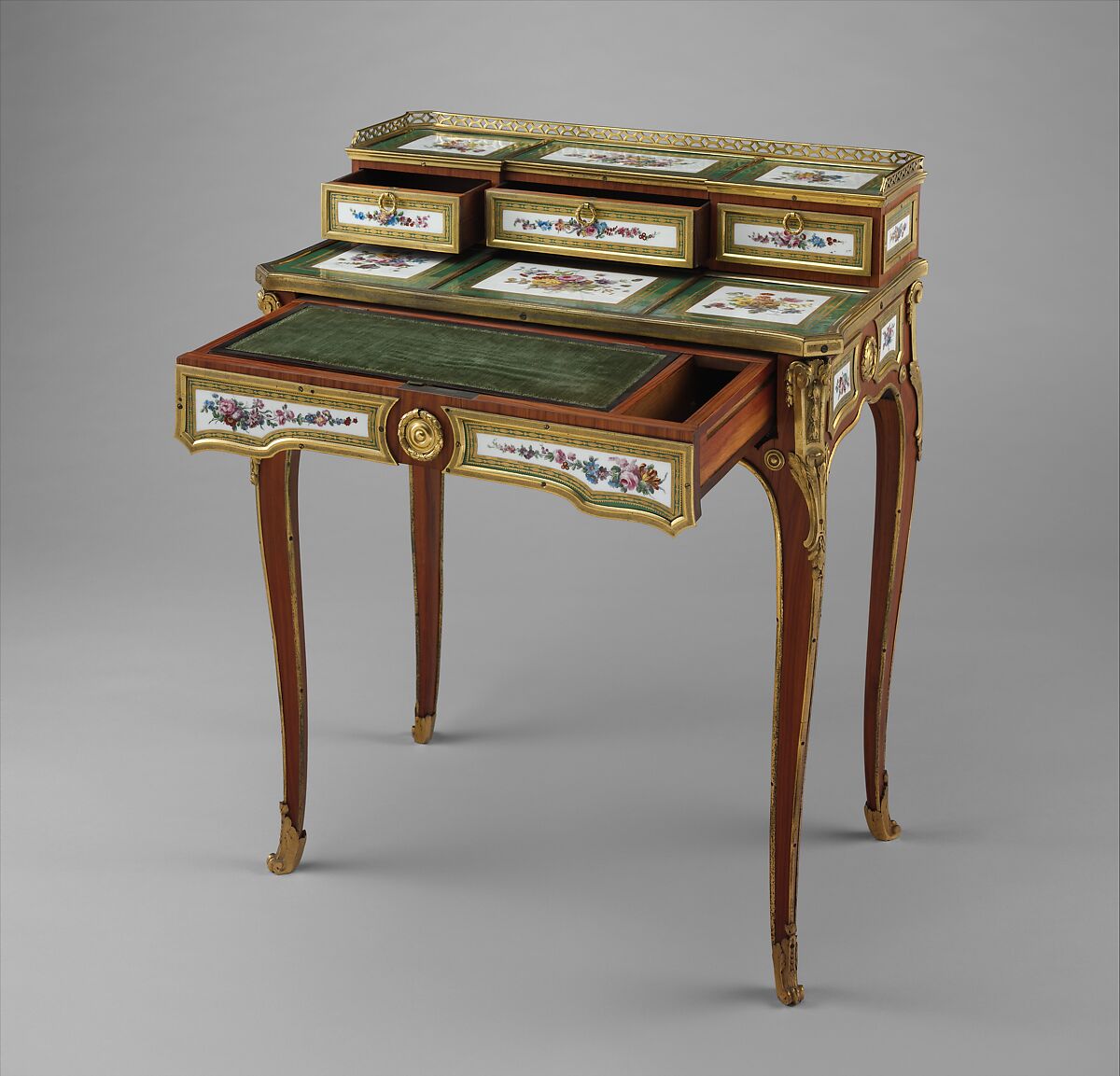 Small writing desk (bonheur-du-jour), Martin Carlin (French, near Freiburg im Breisgau ca. 1730–1785 Paris), Oak veneered with tulipwood, amaranth, and stained sycamore; mahogany; seventeen soft-paste porcelain plaques; gilt-bronze mounts; velvet (not original), French, Paris and Sèvres