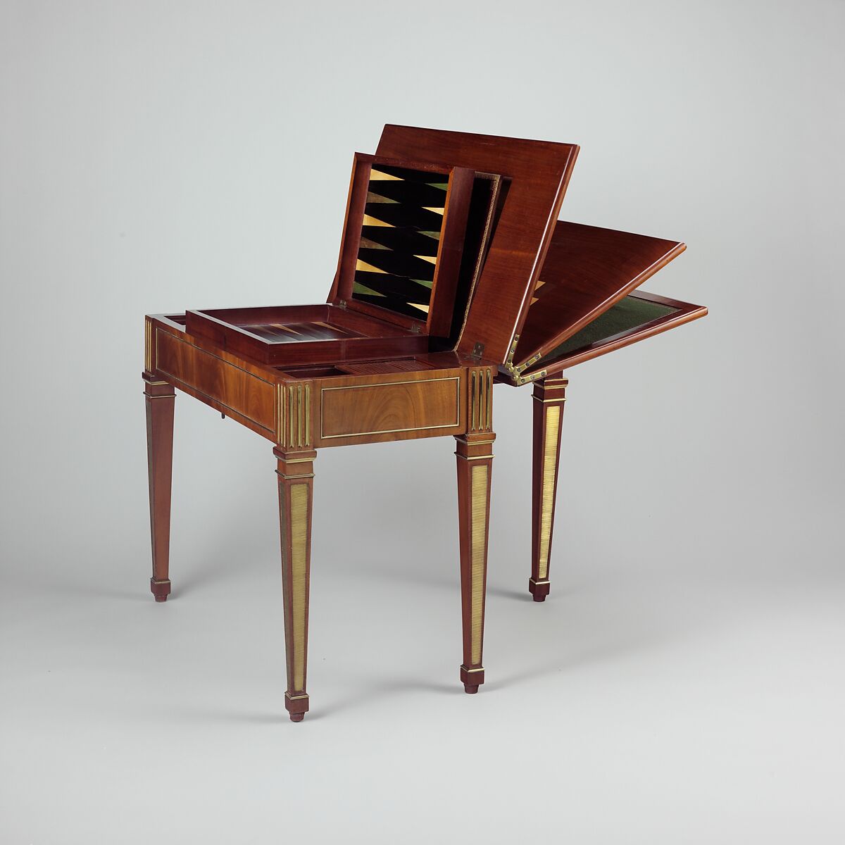 Game table, David Roentgen (German, Herrnhaag 1743–1807 Wiesbaden, master 1780), Oak and walnut, veneered with mahogany, maple, holly (the last two partially stained); iron, steel, brass, gilt bronze; felt and partially tooled and gilded leather, German, Neuwied am Rhine 