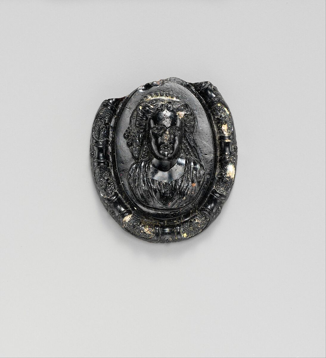 Glass medallion with the bust of a woman or goddess, Glass, Roman, Cypriot 