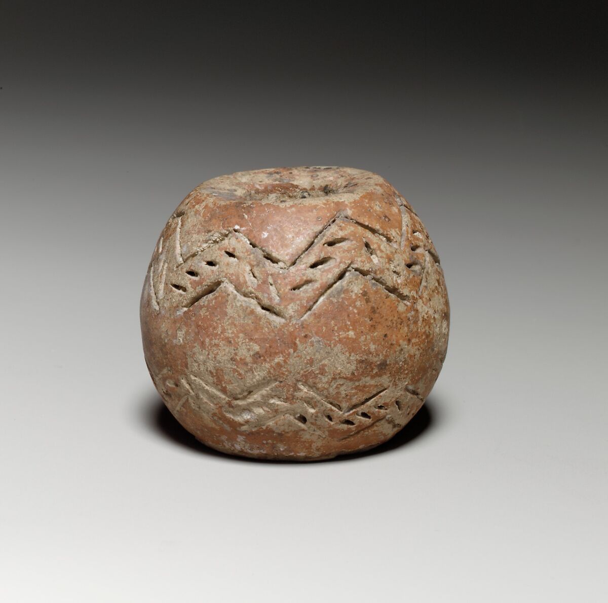 Spherical spindle-whorl with broad flat top and base, Terracotta, Cypriot 