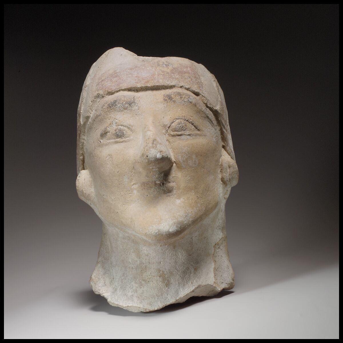 Beardless male head wearing a helmet, Terracotta, Cypriot 