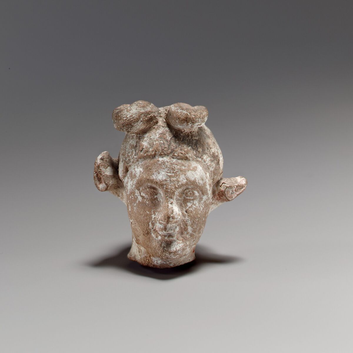 Terracotta head of a youth with a goat headdress, Terracotta, Cypriot 