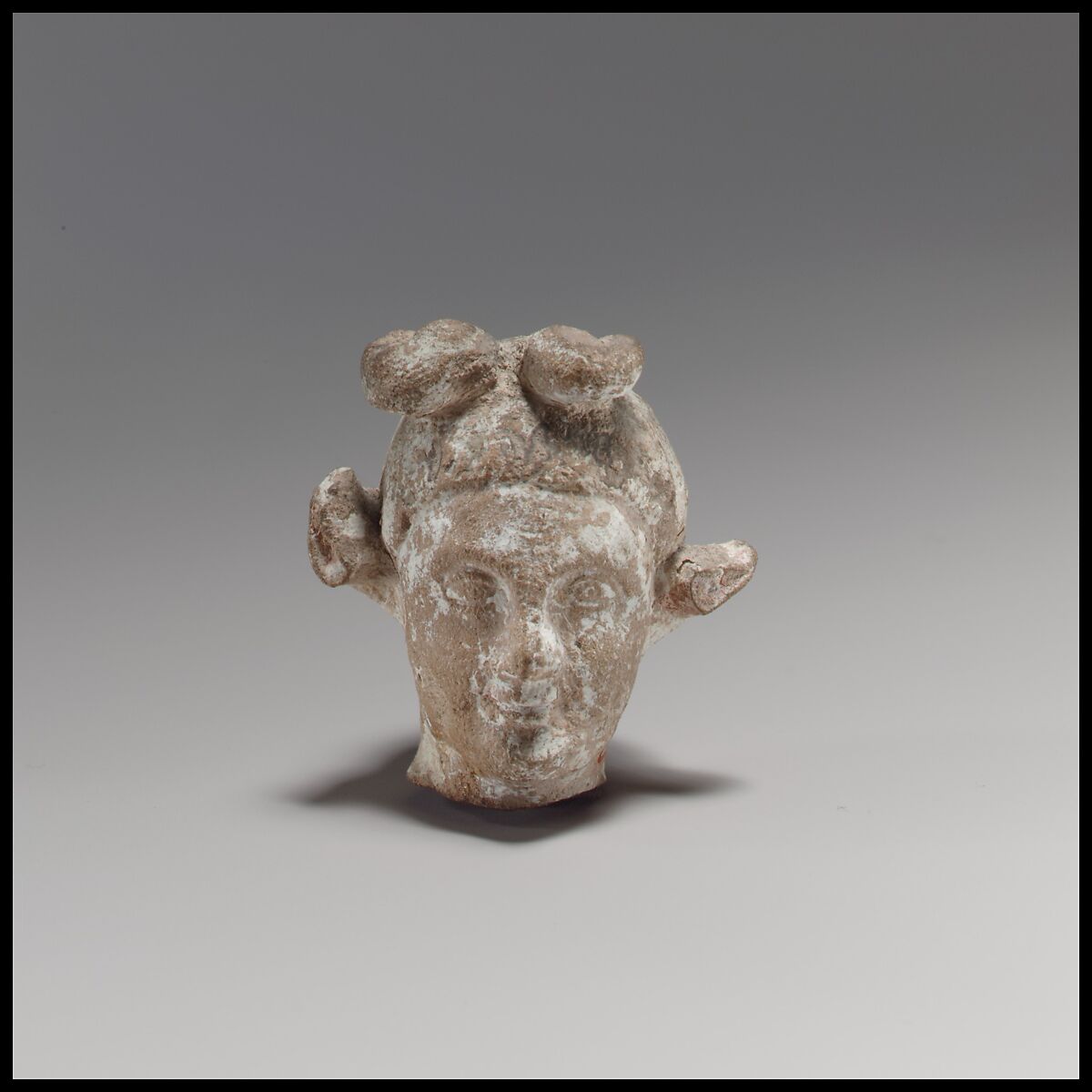 Terracotta head of a youth with a goat headdress, Terracotta, Cypriot