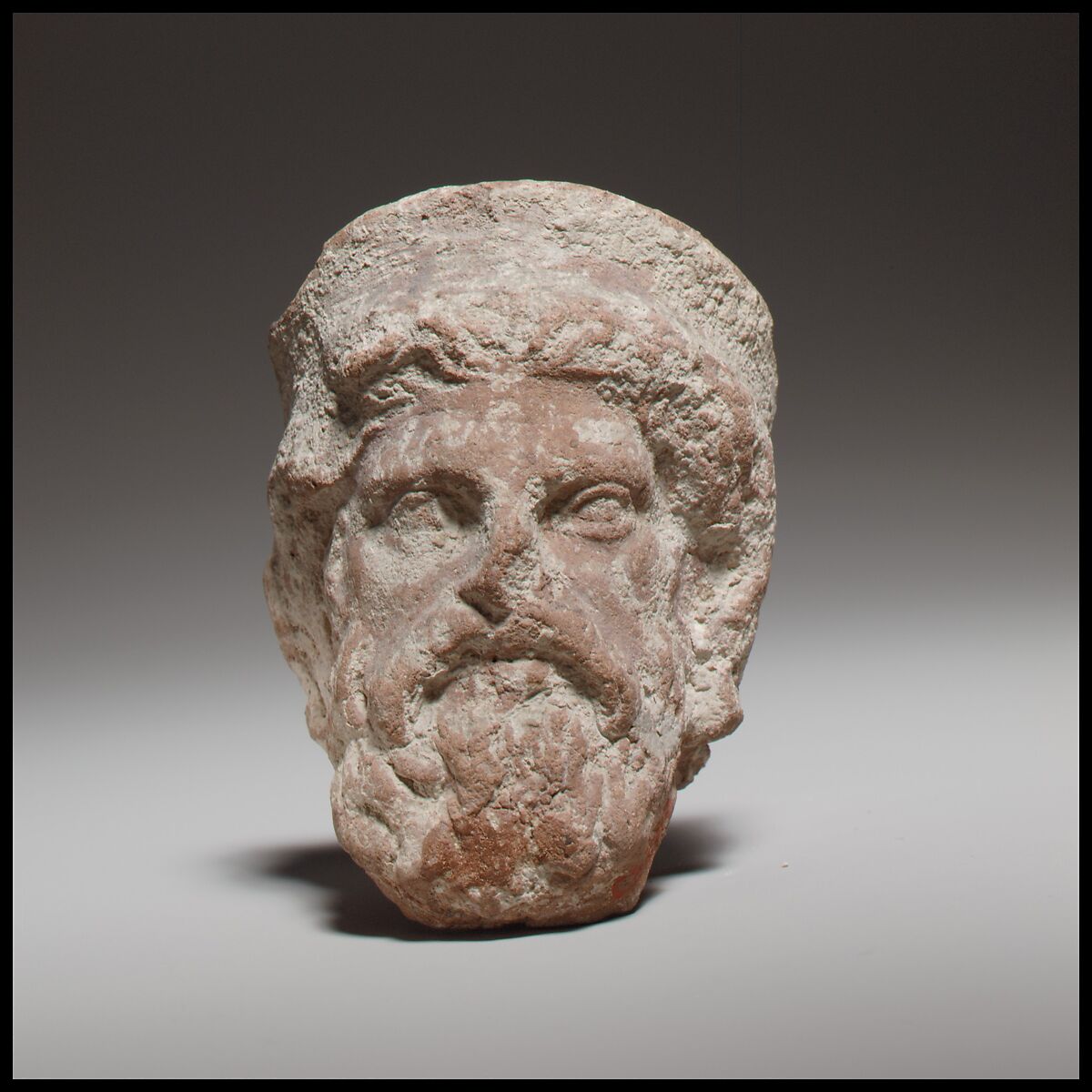 Terracotta head of a bearded god, perhaps Zeus, Terracotta, Cypriot 