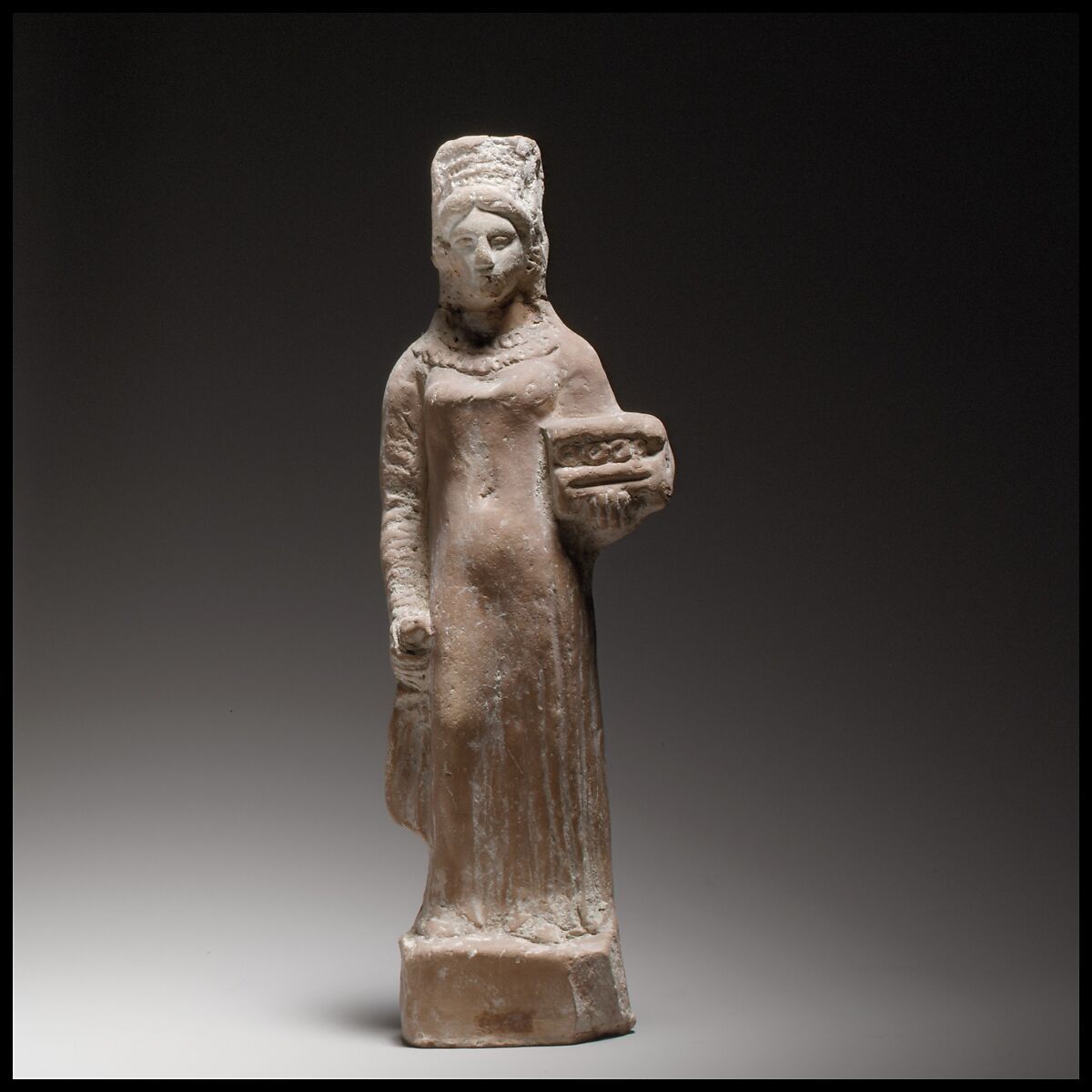 Terracotta figurine of a standing female votary holding a box, Terracotta, Cypriot 