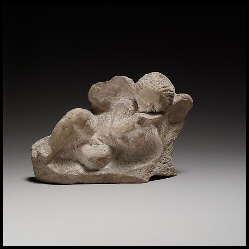 Terracotta statuette of Eros banqueting