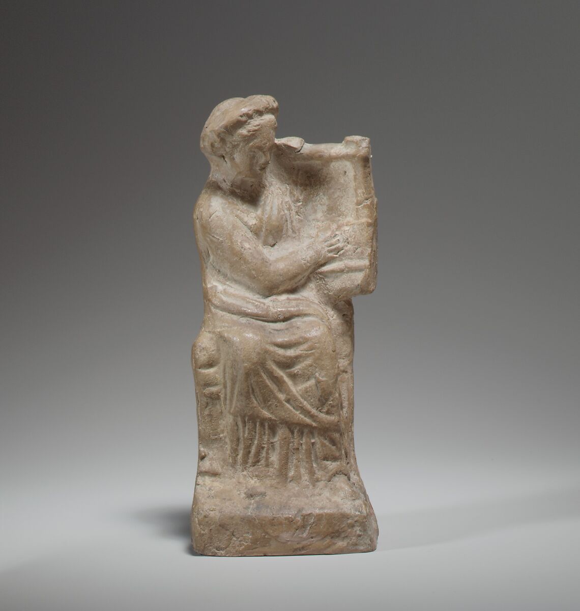 Terracotta statuette of a seated woman playing a kithera, Terracotta, Cypriot