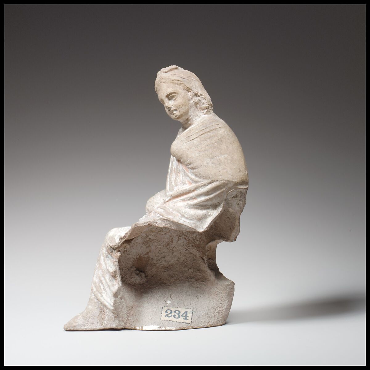 Terracotta statuette of a seated youth, Terracotta, Greek, Cypriot 