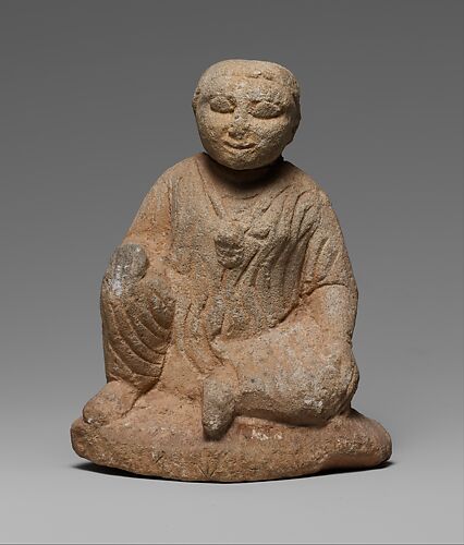 Limestone statuette of a seated temple boy on an inscribed base