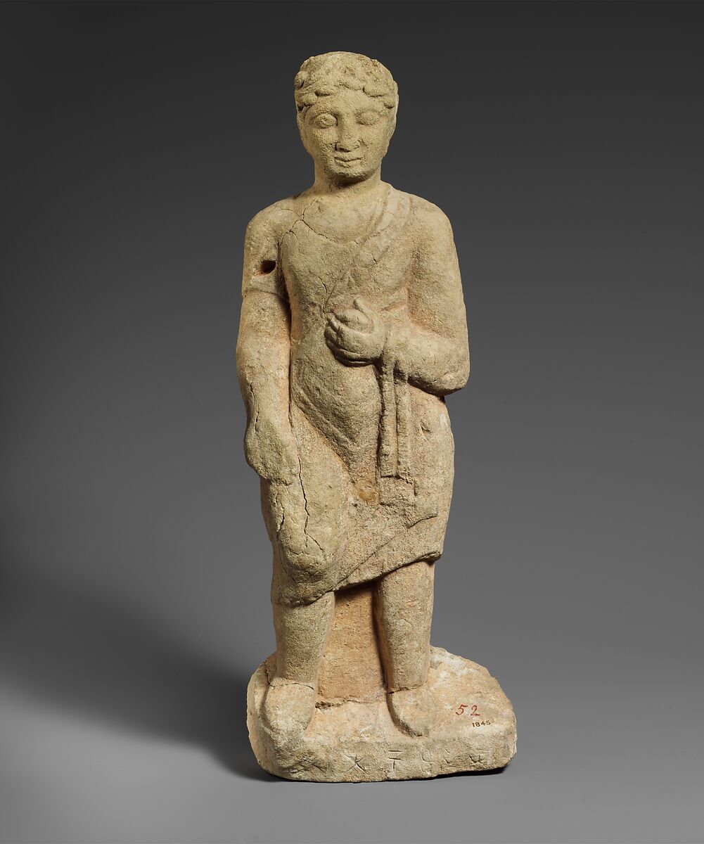 Limestone statuette of a beardless male votary with a wreath of leaves, Hard limestone, Cypriot 