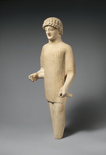 Limestone statue of a male votary wearing a wreath and long tunic