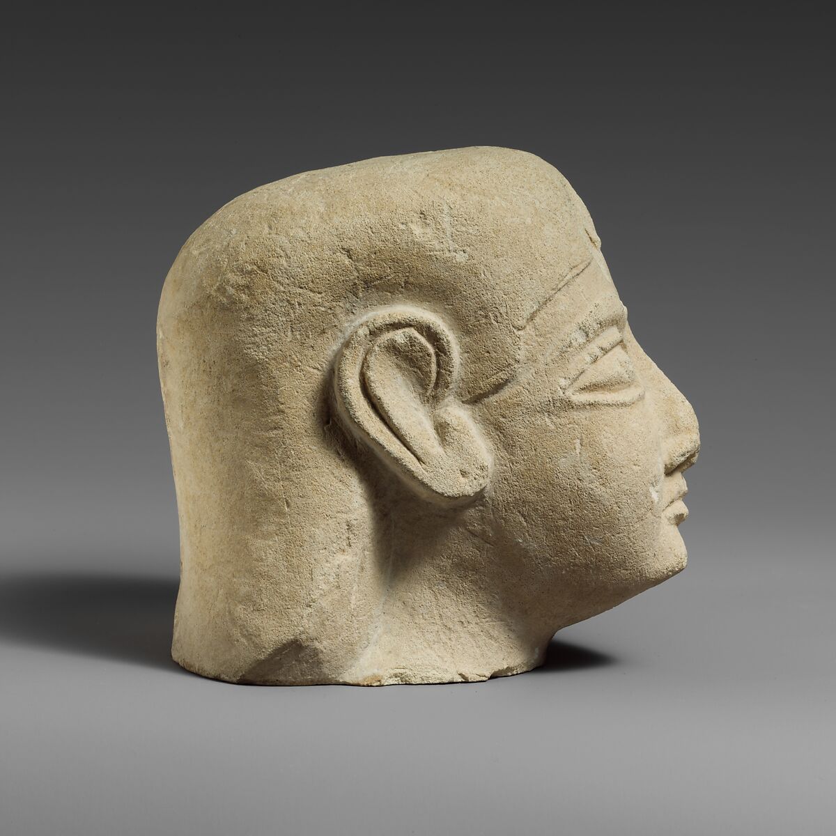 Limestone head of a beardless male with a plain headdress, Limestone, Cypriot