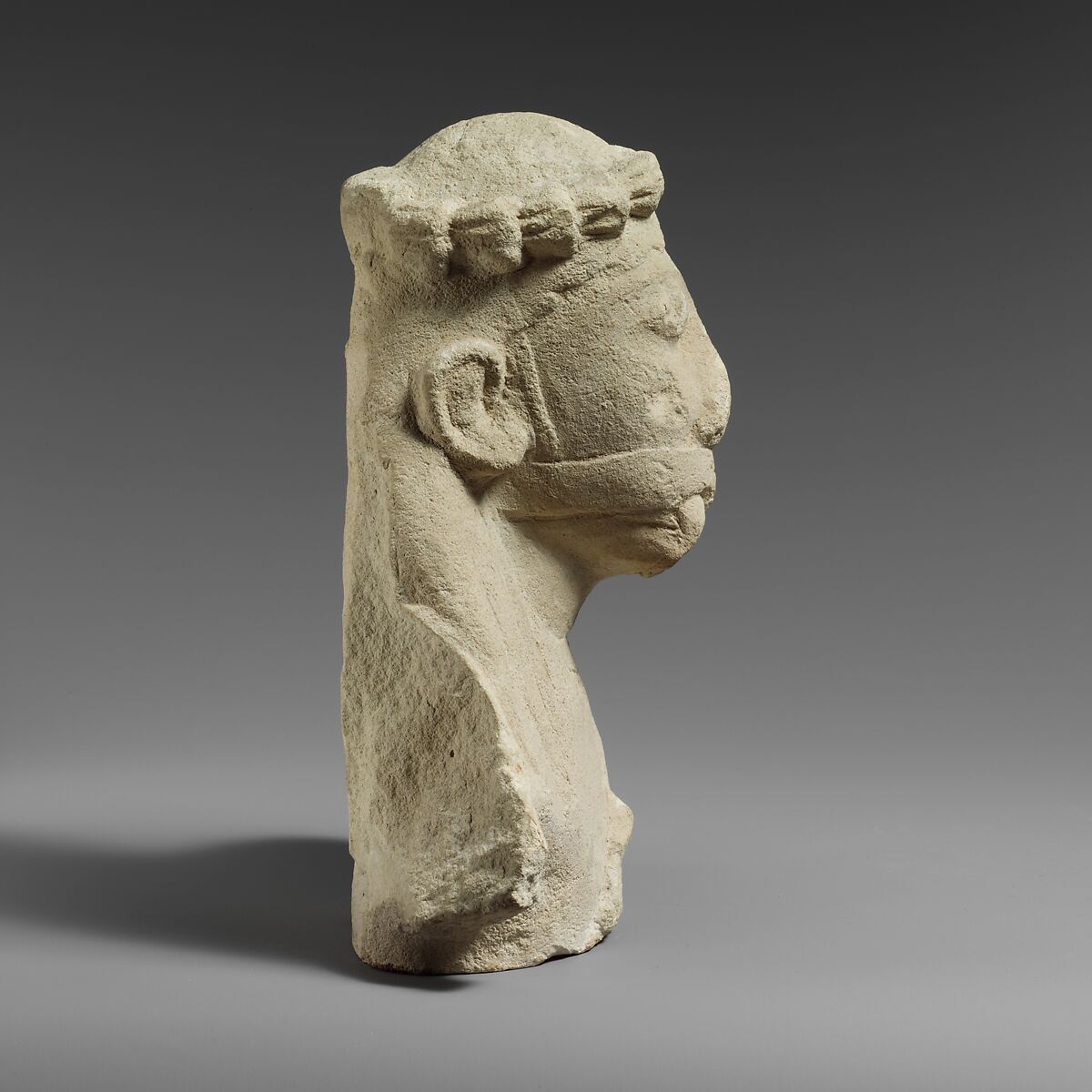 Upper part of a limestone statuette of a male aulos player, Limestone, Cypriot