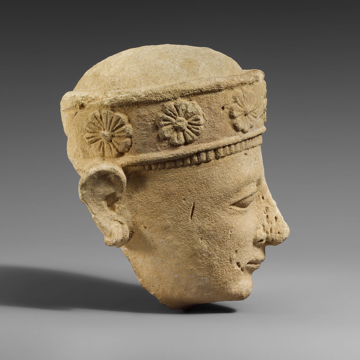 Limestone head of a beardless male with a diadem, Limestone, Cypriot