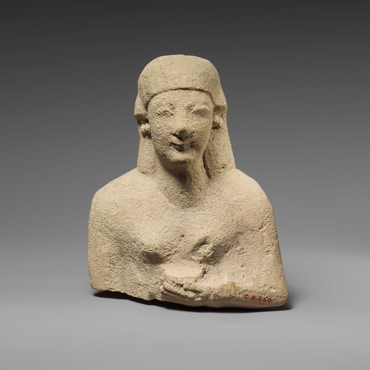 Upper part of a limestone female votary holding a vase, Limestone, Cypriot 