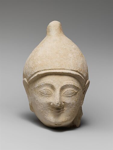 Limestone head of a man wearing a helmet