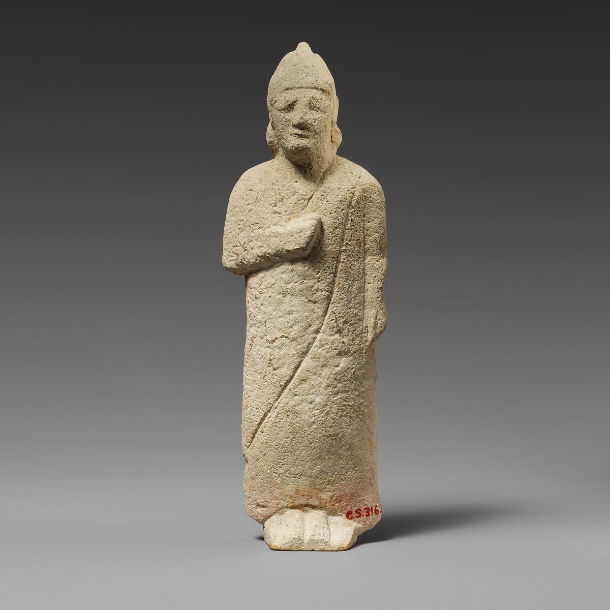 Limestone statuette of a beardless male votary with a conical helmet, Limestone, Cypriot 