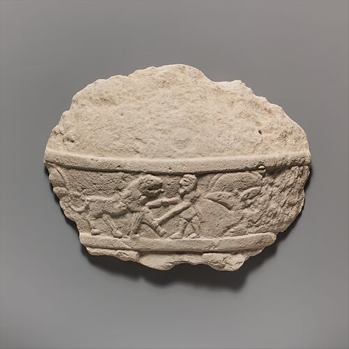 Fragment of a limestone statue of a male votary (worshipper)