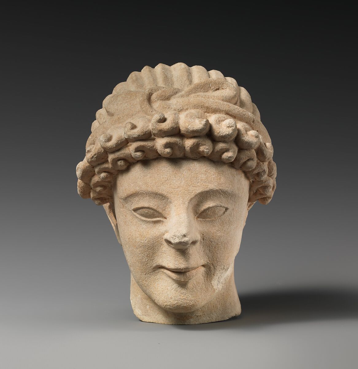 Limestone head of male votary with fillet, Limestone, Cypriot 