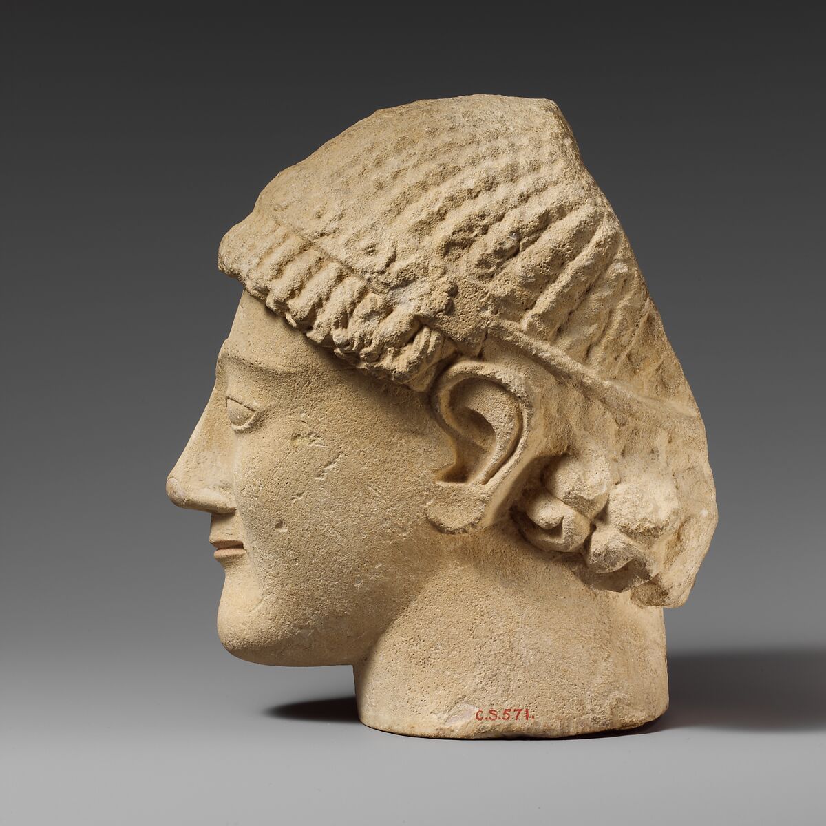 Limestone head of a beardless male votary with a wreath of rosettes, Limestone, Cypriot