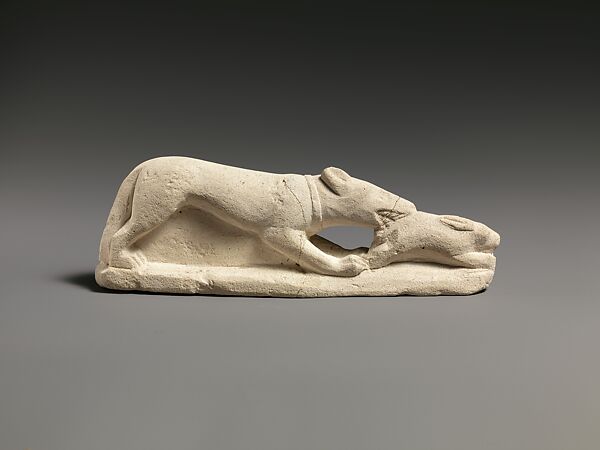 Limestone statuette of a coursing hound seizing a hare