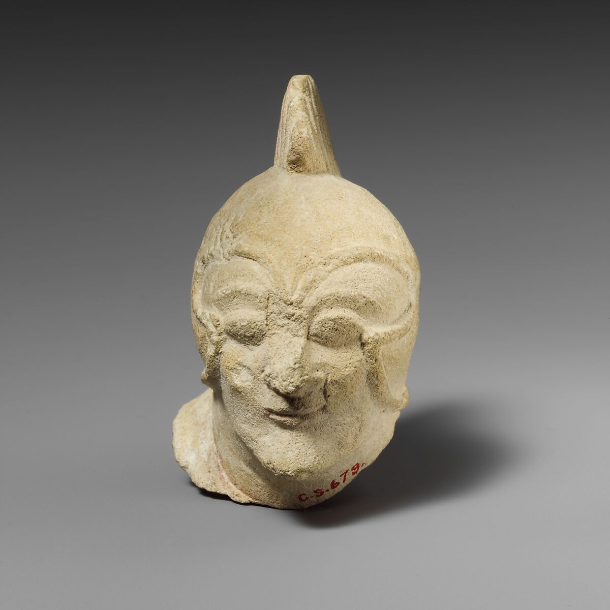 Limestone head of a beardless male with a helmet of Greek type, Limestone, Cypriot 