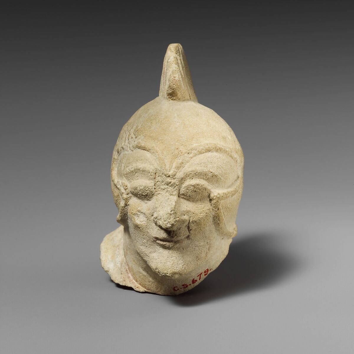 Limestone head of a beardless male with a helmet of Greek type, Limestone, Cypriot