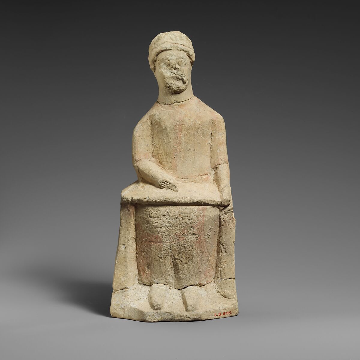 Limestone statuette of a seated beardless male votary writing on a scroll, Limestone, Cypriot 