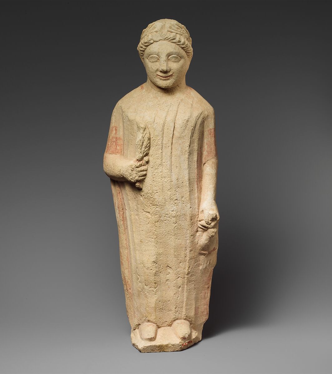 Limestone statuette of a boy holding a bird and a branch of leaves ...