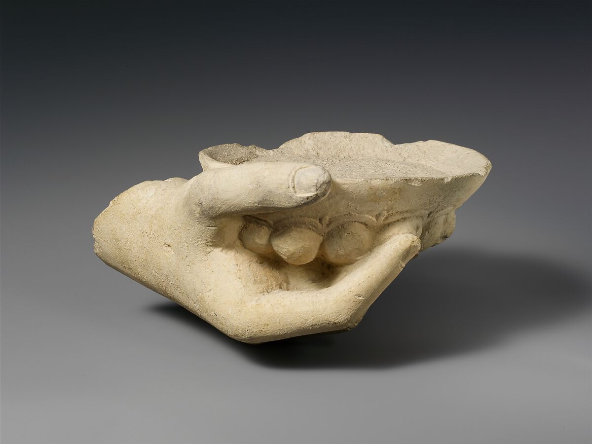 Limestone statue fragment of a right hand holding a phiale (libation bowl), Limestone, Cypriot 