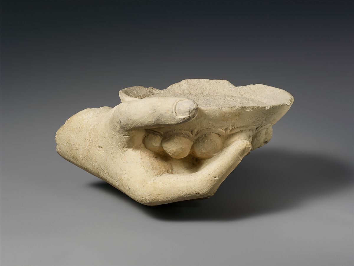 Limestone statue fragment of a right hand holding a phiale (libation bowl), Limestone, Cypriot