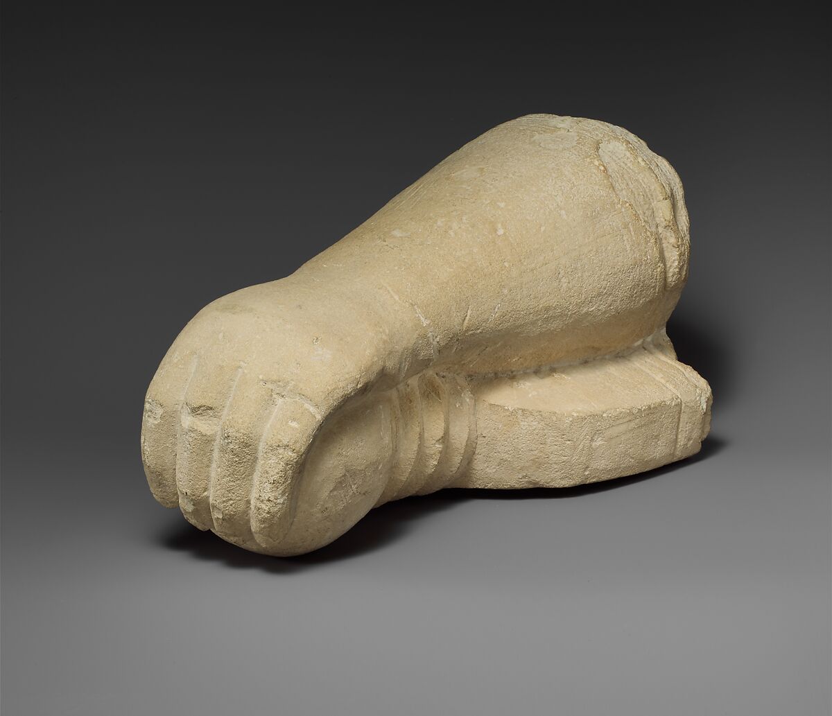 Limestone arm holding a sword, Limestone, Cypriot 