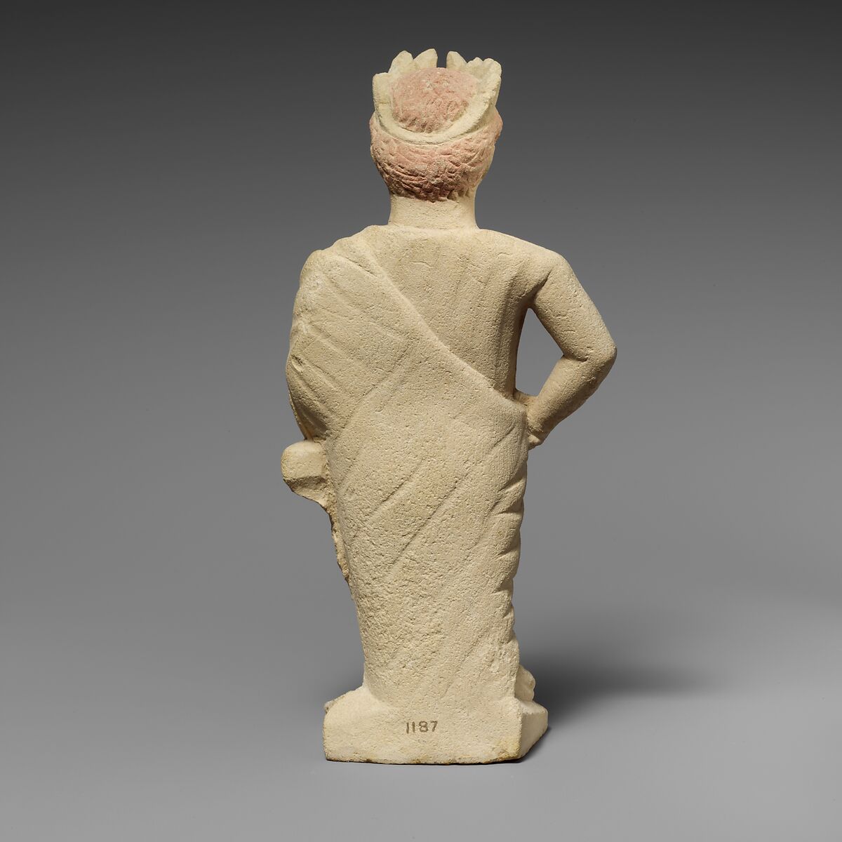 Limestone statuette of a beardless male votary with a wreath of leaves, Limestone, Cypriot