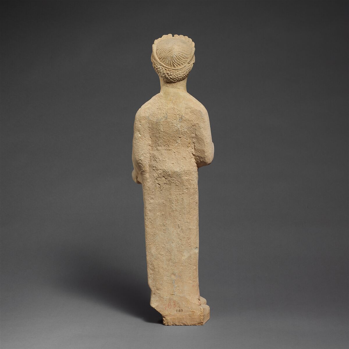 Limestone statuette of a beardless male votary with a wreath of leaves, Limestone, Cypriot