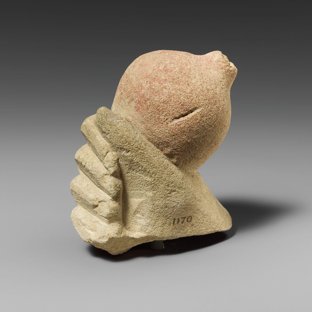 Limestone hand holding a pomegranate, Limestone, Cypriot 