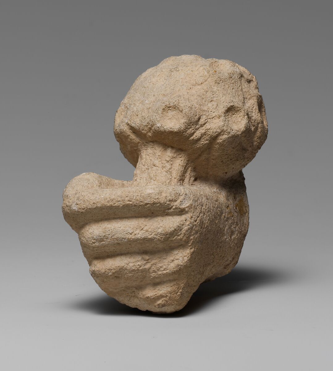 Limestone statue fragment of a left hand holding a bunch of daisies, Limestone, Cypriot 