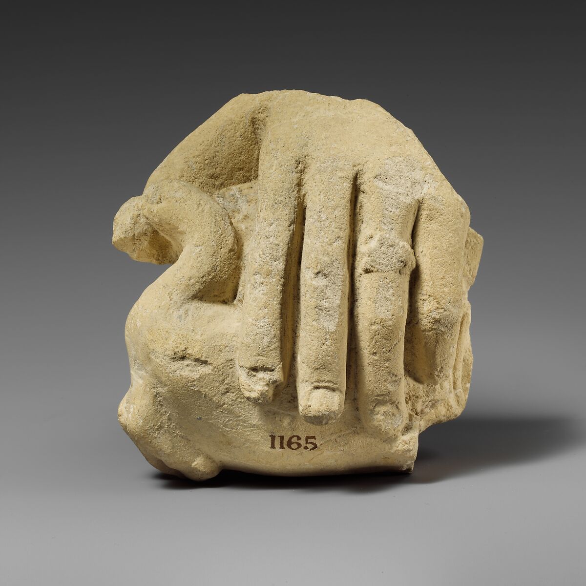 Limestone hand holding a bird, Limestone, Cypriot 