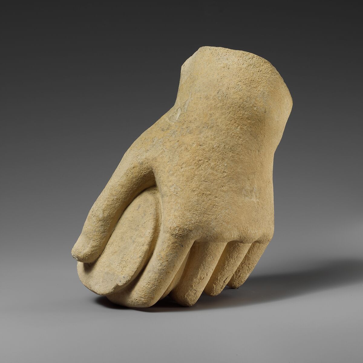 Limestone hand holding a pyxis, Limestone, Cypriot 