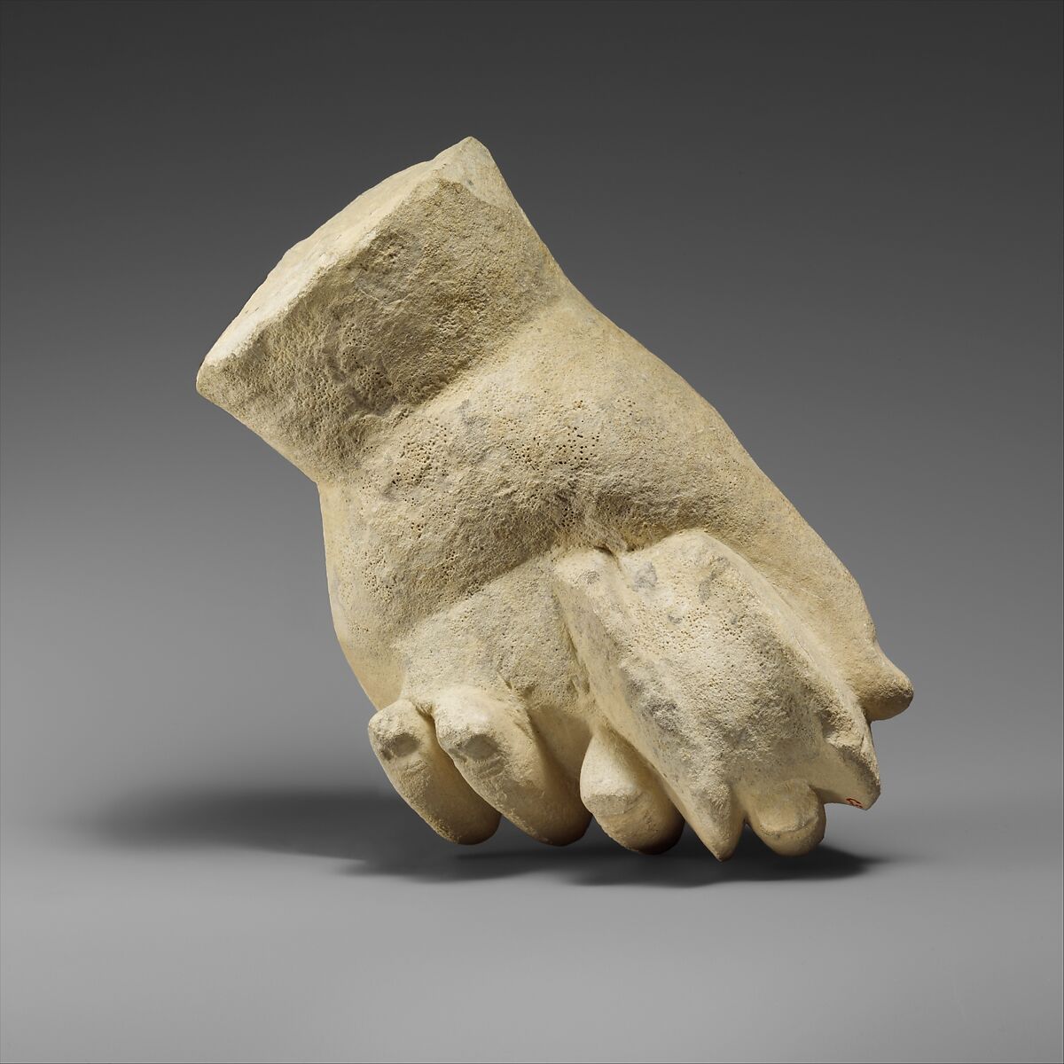 Limestone hand holding a pyxis, Limestone, Cypriot