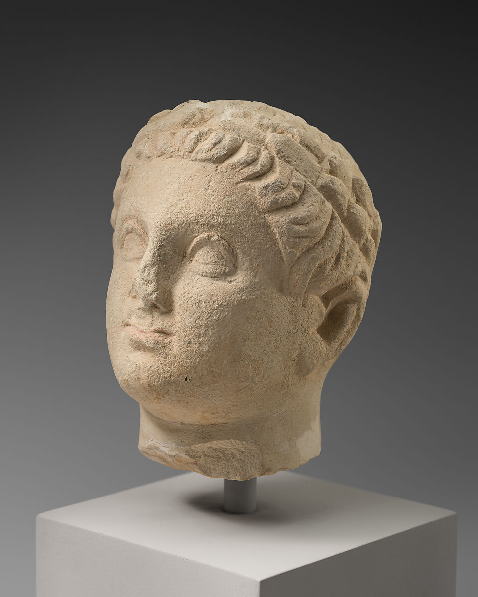 Limestone statuette of a boy holding an amphora, Limestone, Cypriot