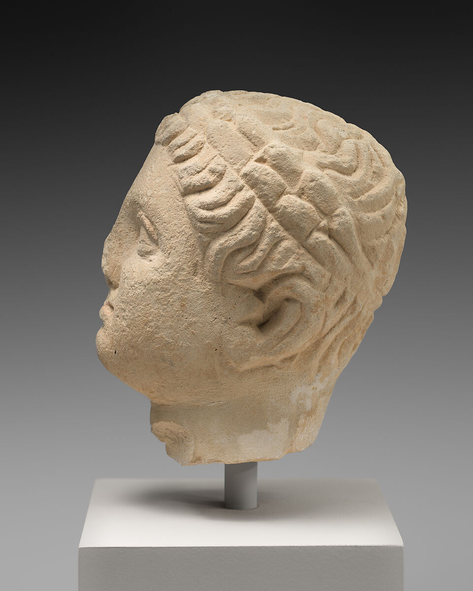 Limestone statuette of a boy holding an amphora, Limestone, Cypriot