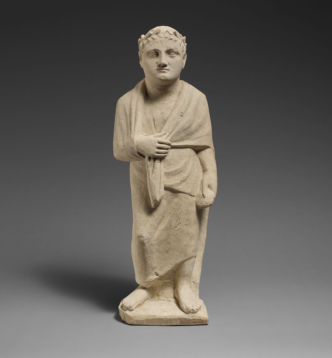 Limestone statuette of a boy holding a pyxis, Limestone, Cypriot 