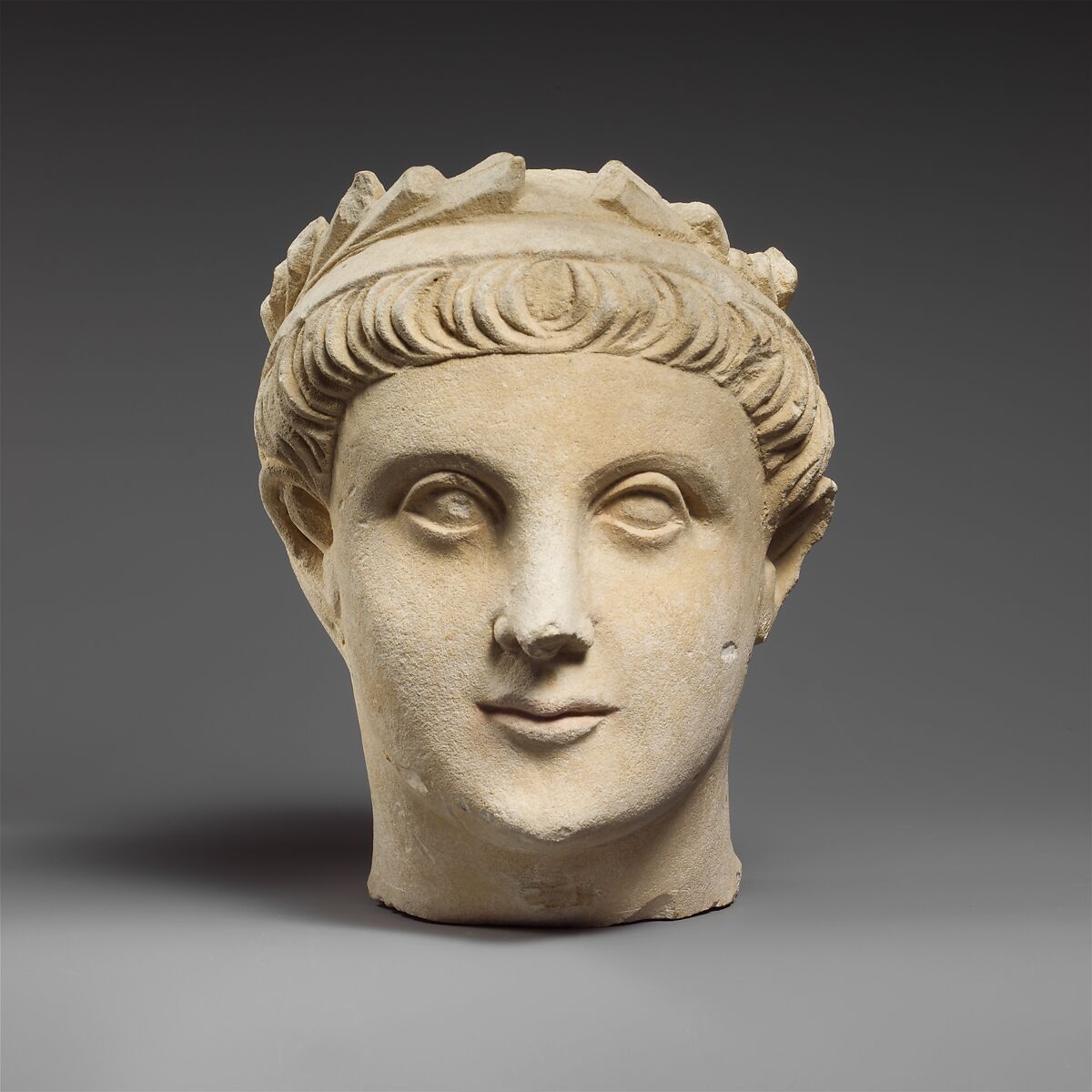 Limestone head of a wreathed youth, Limestone, Cypriot 